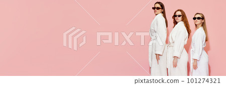 Three beautiful girls in bathrobes and sunglasses standing against pink studio background Three beautiful girls in bathrobes and sunglasses standing against pink studio background 101274321