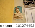 Traditional religious catholic bas-relief od Virgin Mary with baby Jesus near the building entrance in Mdina, Malta. 101274458