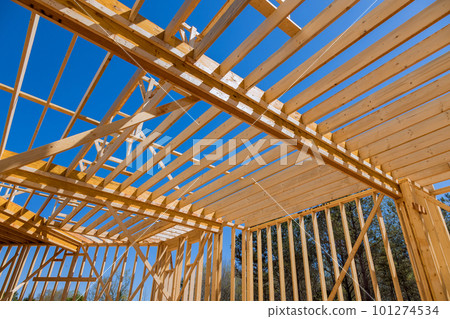 New framework is under construction of framed beams in laying floor joists truss laying second floor construction of newly house New framework is under construction of framed beams in laying floor joists truss laying second floor construction of newly house 101274534