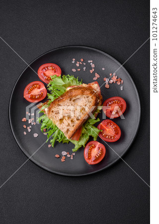 Delicious caprese sandwich with grilled toast, mozzarella, lettuce and tomatoes Delicious caprese sandwich with grilled toast, mozzarella, lettuce and tomatoes 101274643