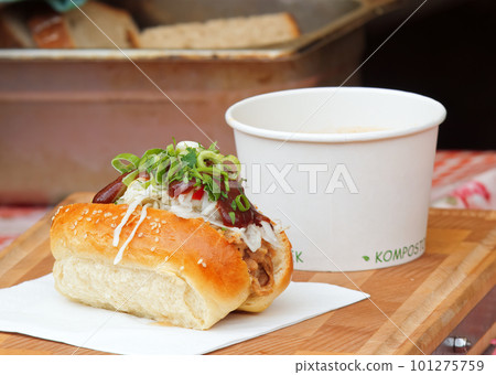 A bun stuffed with pulled meat and vegetables at farmers market. 101275759