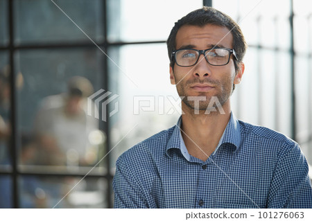Portrait of a handsome businessman in his office 101276063