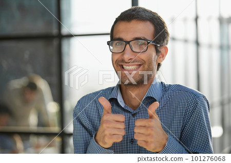 Young businessman in casual wear approves positive hand gesture Young businessman in casual wear approves positive hand gesture 101276068