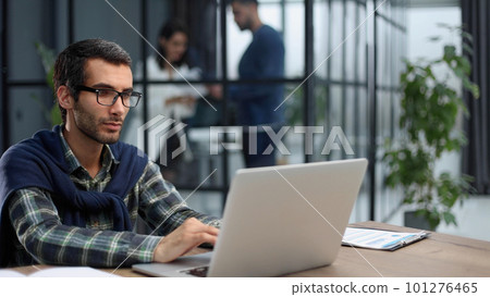 business man working on laptop in modern office. business man working on laptop in modern office. 101276465