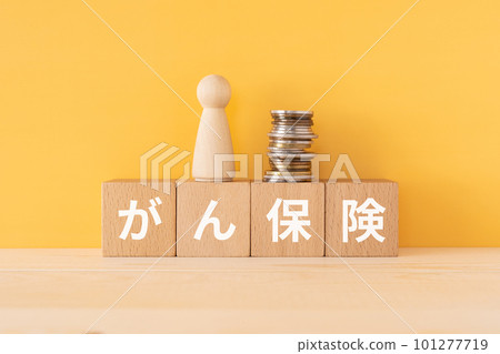 Blocks, dolls and coins written as cancer insurance 101277719