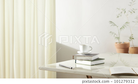 A room with a calm atmosphere, with clay pots placed in front of the wall and curtains letting in natural light. Glass bottles, coffee, and various objects on a marble table 101279312