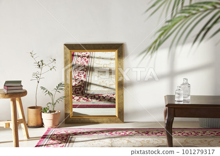 A room with a calm atmosphere, with clay pots placed in front of the wall and curtains letting in natural light. Glass bottles, coffee, and various objects on a marble table 101279317