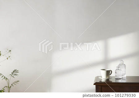 A room with a calm atmosphere, with clay pots placed in front of the wall and curtains letting in natural light. Glass bottles, coffee, and various objects on a marble table A room with a calm atmosphere, with clay pots placed in front of the wall and curtains letting in natural light. Glass bottles, coffee, and various objects on a marble table 101279330