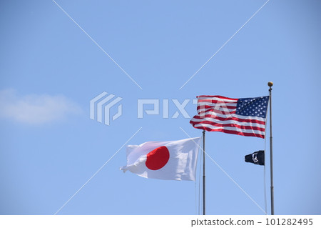 Japanese and American flags fluttering in the blue sky Japanese and American flags fluttering in the blue sky 101282495