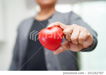 Asian woman holding red heart with rainbow flag, LGBT symbol rights and gender equality, LGBT Pride Month in June. 101282787