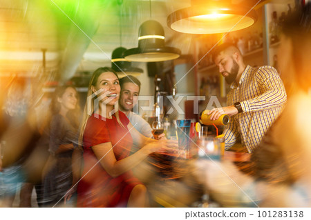 Man bartender making alcohol cocktail for couple in nightclub 101283138