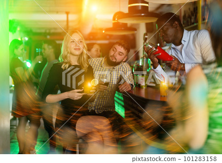 African american man bartender making cocktail for couple African american man bartender making cocktail for couple 101283158