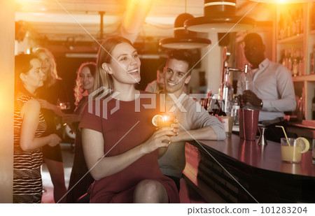 Cheerful girl with best friends partying in bar, dancing and toasting drinks Cheerful girl with best friends partying in bar, dancing and toasting drinks 101283204