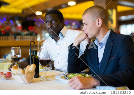 Man shares problems with his friend at a table in restaurant 101283230