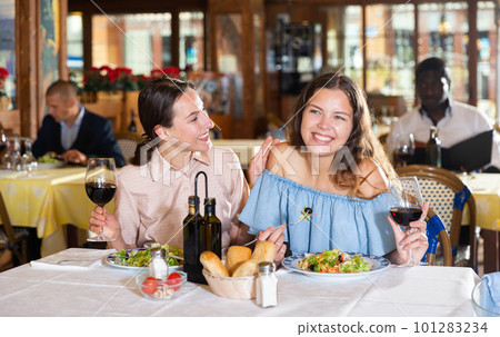 Couple enjoying dinner with wine at restaurant 101283234
