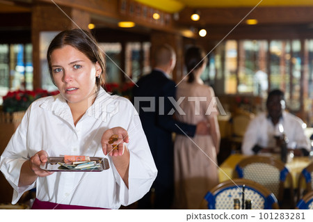 Woman waiter demonstrating her upset with small tip 101283281