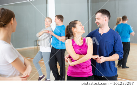 Young couple practicing active dance in pair Young couple practicing active dance in pair 101283297