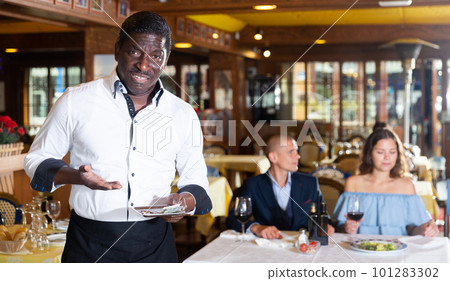 Waiter expressing displeasure with small tip Waiter expressing displeasure with small tip 101283302