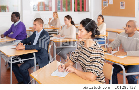 Interested adult korean woman on lesson in school auditorium Interested adult korean woman on lesson in school auditorium 101283438