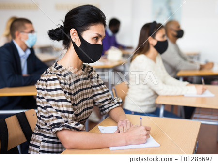 Asian woman in protective mask during lesson in school for adults 101283692