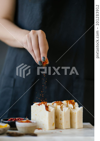 The girl sprinkles the soap with saffron The girl sprinkles the soap with saffron 101283912