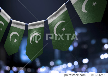 A garland of Pakistan national flags on an abstract blurred background 101284246