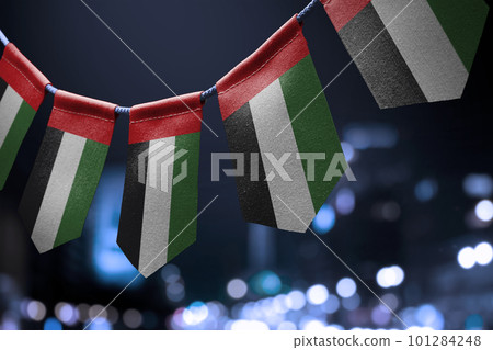 A garland of United Arab Emirates national flags on an abstract blurred background 101284248