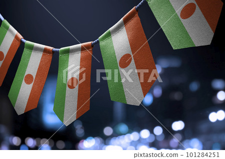 A garland of Niger national flags on an abstract blurred background A garland of Niger national flags on an abstract blurred background 101284251