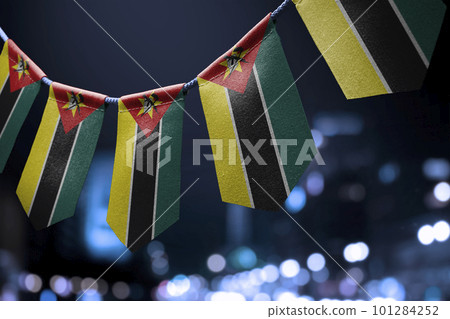 A garland of Mozambique national flags on an abstract blurred background A garland of Mozambique national flags on an abstract blurred background 101284252