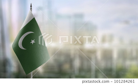 Small flags of the Pakistan on an abstract blurry background 101284261