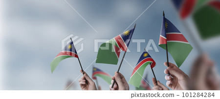 A group of people holding small flags of the Namibia in their hands 101284284