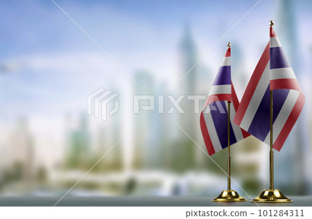 Small flags of the Thailand on an abstract blurry background Small flags of the Thailand on an abstract blurry background 101284311