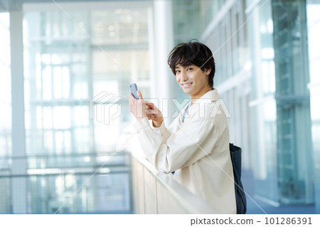 Portrait of a young man operating a smartphone Portrait of a young man operating a smartphone 101286391