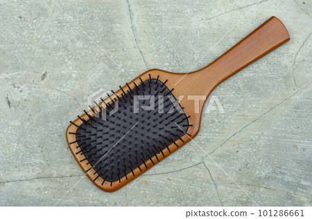 Bamboo Paddle Hair Brush isolated on cement Background 101286661