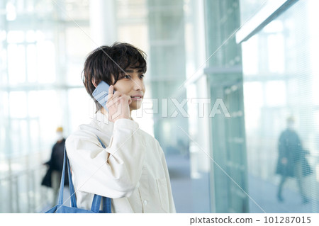 A young man talking on a smartphone A young man talking on a smartphone 101287015