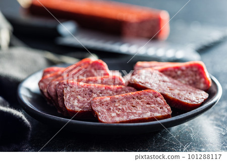 Smoked .sausage. Sliced salami on plate. Smoked .sausage. Sliced salami on plate. 101288117