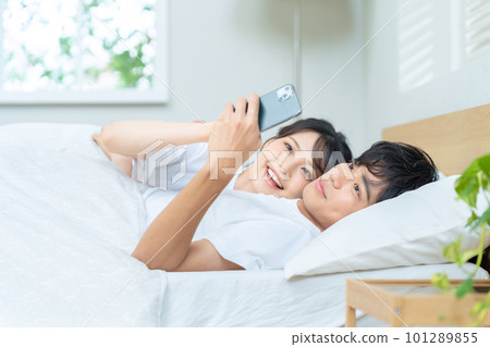 Couple couple family newlywed smartphone lifestyle bedroom sleep Couple couple family newlywed smartphone lifestyle bedroom sleep 101289855