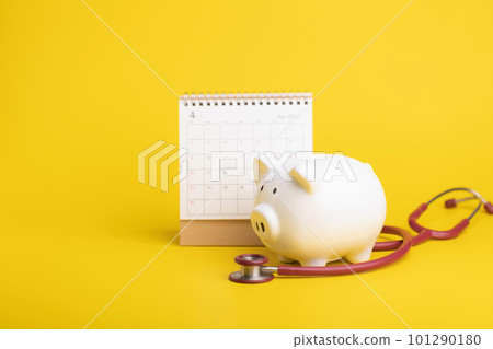 pink piggy bank and money on yellow background pink piggy bank and money on yellow background 101290180