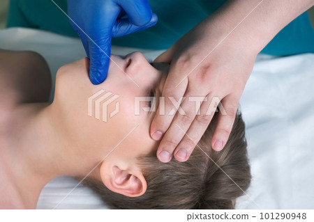 Session of craniosacral therapy, cure of teen boy's jaws by a doctor therapist. 101290948