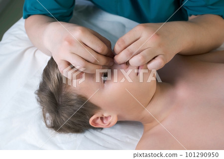 Session of craniosacral therapy, cure of teen boy's nose by a doctor therapist. 101290950