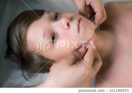 Session of craniosacral therapy, cure of teen boy's jaw by a doctor therapist. 101290955