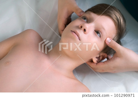 Session of craniosacral therapy, cure of teen boy's neck by a doctor therapist. 101290971