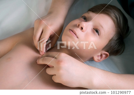 Session of craniosacral therapy, cure of teen boy spine by a doctor therapist. 101290977