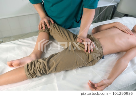 Session of craniosacral therapy, cure of teen boy's leg by doctor therapist. 101290986