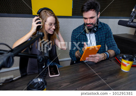 Young man and woman looking involved while searching something online Young man and woman looking involved while searching something online 101291381