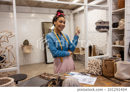 Cute young woman in an art studio looking joyful 101291404