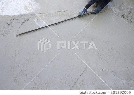 Workers plastering ready mixed concrete floor at the construction agency. 101292009