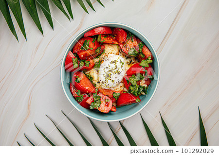 Hummus bowl with poached egg and tomatoes Hummus bowl with poached egg and tomatoes 101292029
