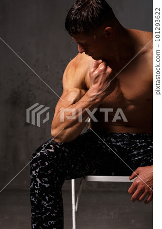 A guy in a great sports uniform in the studio on a gray background. 101293622