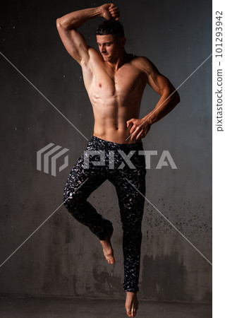 A guy in a great sports uniform in the studio on a gray background. A guy in a great sports uniform in the studio on a gray background. 101293942